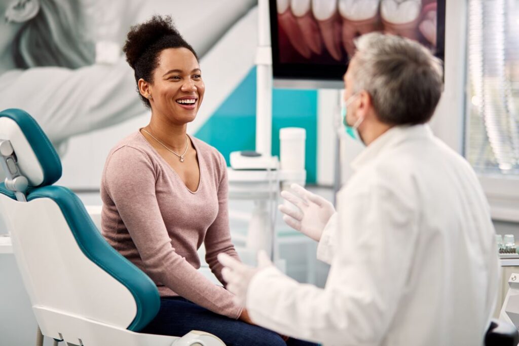 A woman discussing a smile makeover with her dentist